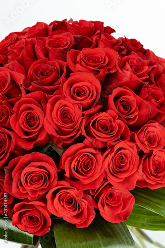 Bouquet of red roses with orange bow.