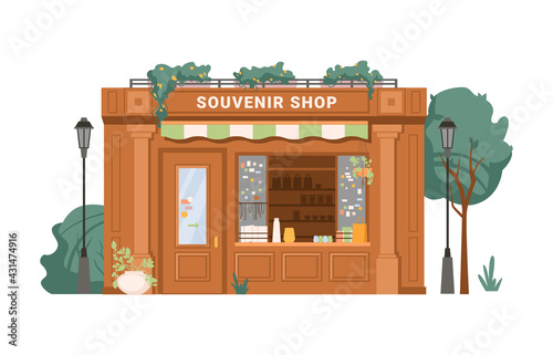 Fototapeta Naklejka Na Ścianę i Meble -  Souvenir shop facade exterior isolated small retail business building flat cartoon. Vector antique store, collectables in shop window, presents, gifts, decorative vases. Green trees, street lamps