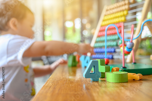 Obraz na płótnie Asian preschool age play with colorful toy alone