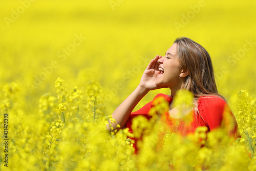 Woman shouting in a yellow field