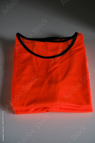 two training bibs, light green and red