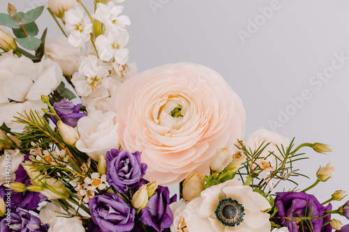 Woman face in the shape of a vase for flowers with Anemone eustoma ranunculus. photo