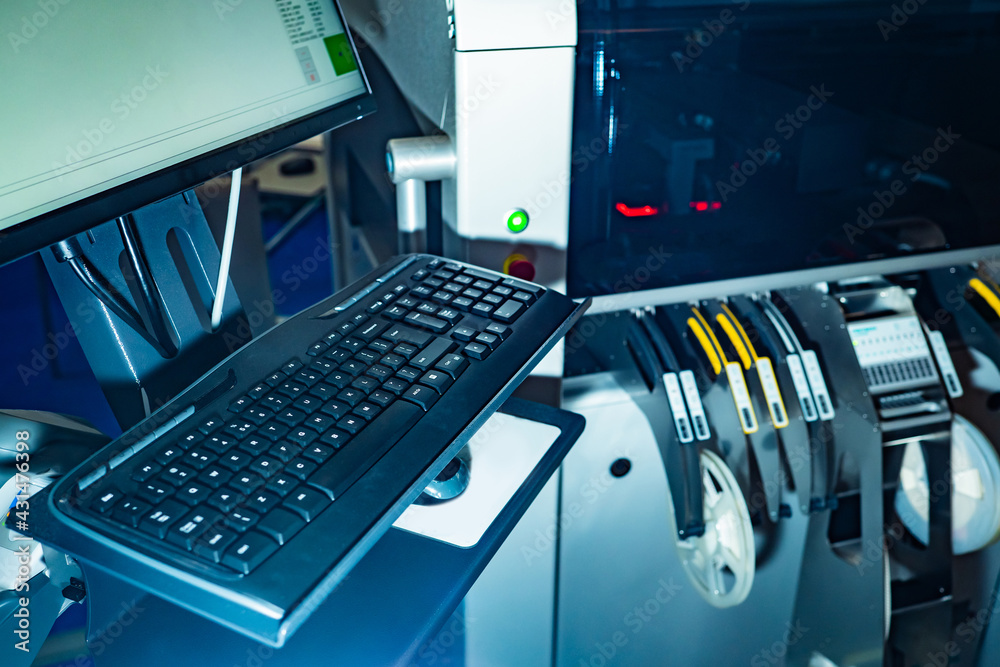 Fototapeta premium Equipment in the laboratory for the production of printed circuit boards. Automated PCB soldering system. Radio-electronic laboratory. A machine for assembling printed circuit boards.