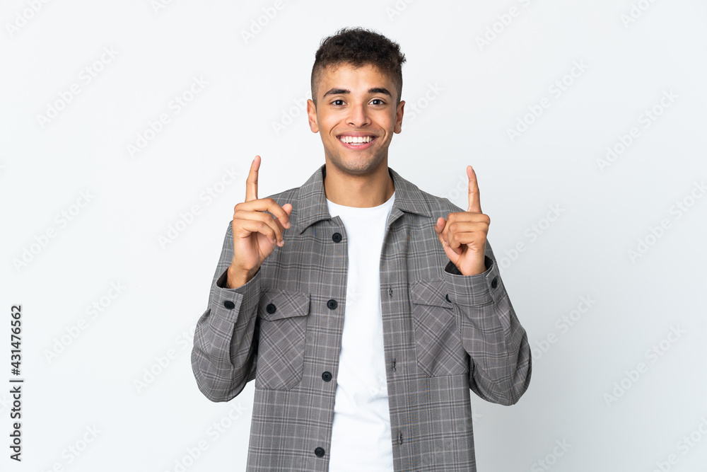 Young brazilian man isolated on white background pointing up a great idea Young brazilian man isolated on white background pointing up a great idea
