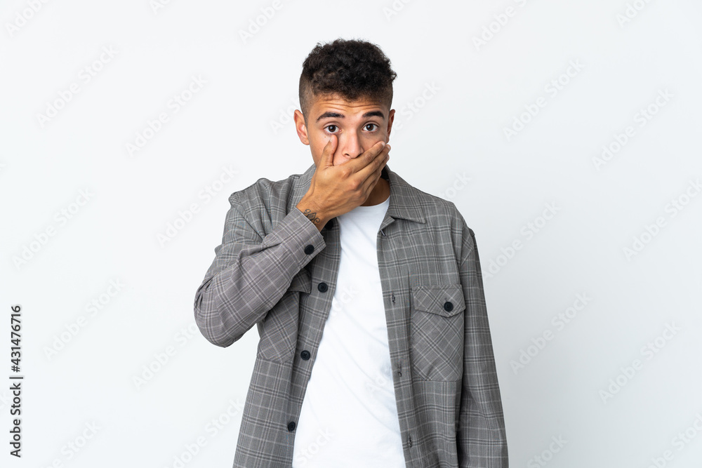 Young brazilian man isolated on white background covering mouth with hand Young brazilian man isolated on white background covering mouth with hand