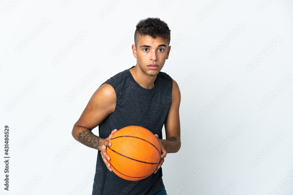 Young Brazilian man over isolated background playing basketball Young Brazilian man over isolated background playing basketball