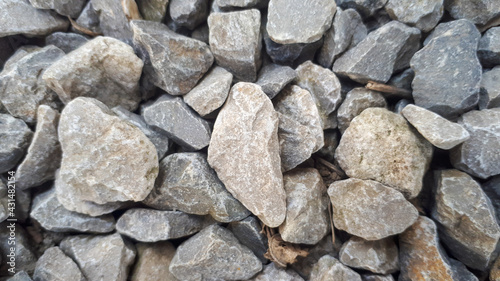 Gravel stones flooring pattern surface texture. Close-up of exterior material. Small road stone background, dark gravel pebbles stone