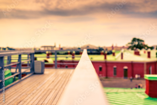 Summer in the city, a walking terrace with panoramic views of the city. Close up view from the handrail on the sidewalk level © Georgii Shipin