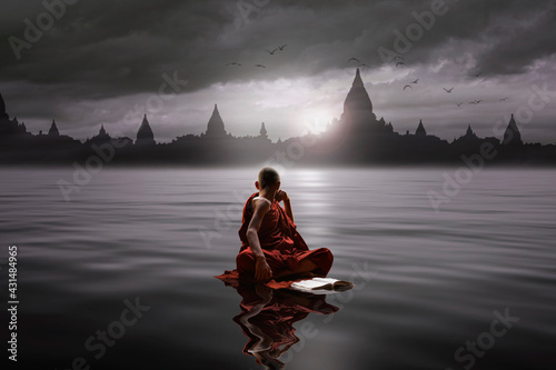 Fotografía Buddhist monk sitting in the water and looking at the temple