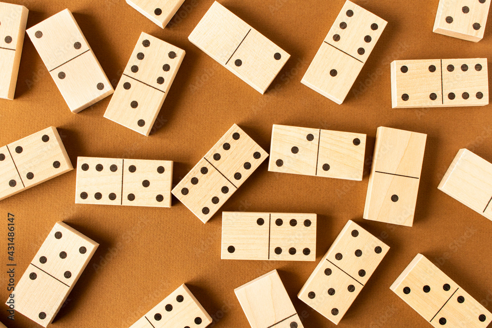 A game of dominoes on a brown background. Close-up. Selective focus. A game of dominoes on a brown background. Close-up. Selective focus.