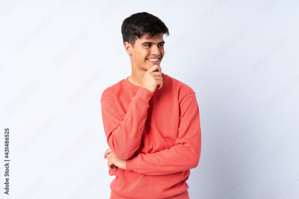 Handsome man over isolated blue background looking to the side and smiling Handsome man over isolated blue background looking to the side and smiling
