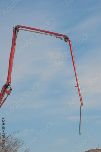 Arrow construction crane on a blue sky background, construction