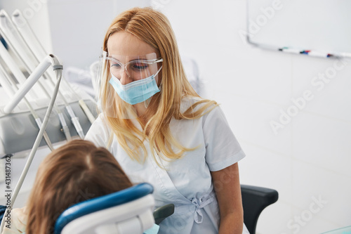 Orthodontist taking care of her small patient