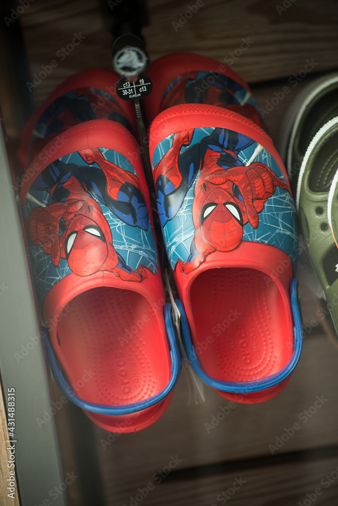 Naklejka premium Mulhouse - France - 2 May 2021 - Closeup of spiderman shoes for kids in a fashion store showroom