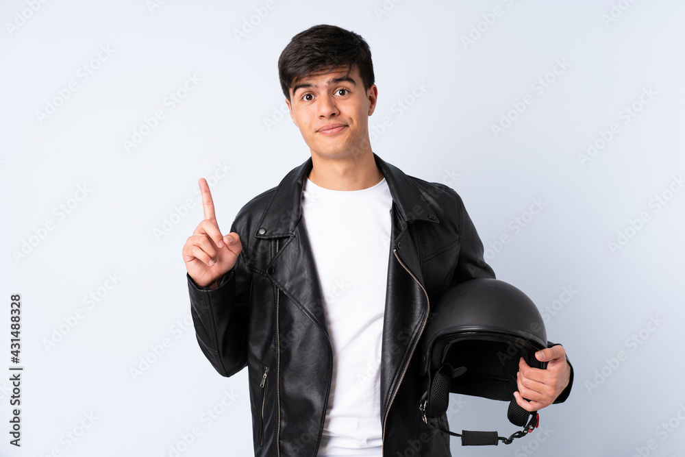 Man with a motorcycle helmet over isolated blue background pointing with the index finger a great idea Man with a motorcycle helmet over isolated blue background pointing with the index finger a great idea