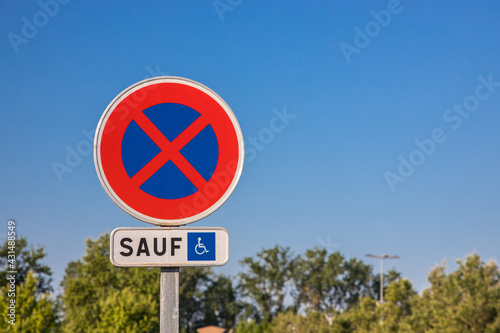 French road sign indicating a space reserved "only" for disabled people