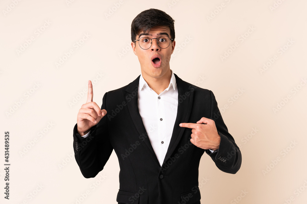 Businessman over isolated beige background with surprise facial expression Businessman over isolated beige background with surprise facial expression