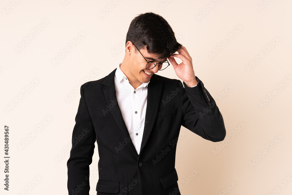 Businessman over isolated beige background laughing Businessman over isolated beige background laughing