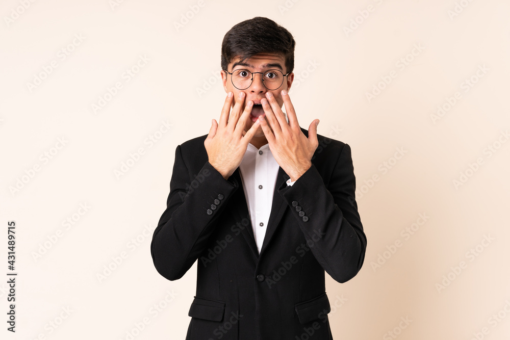 Businessman over isolated beige background with surprise facial expression Businessman over isolated beige background with surprise facial expression
