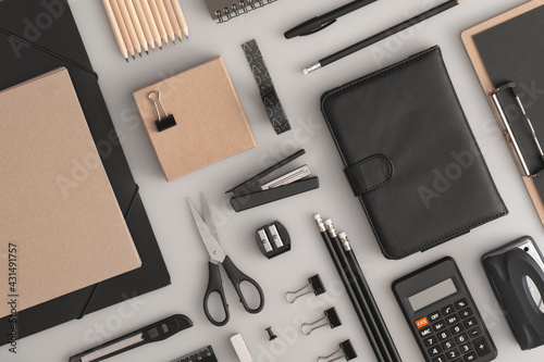 Foto Pattern composition of office and school stationery on grey background
