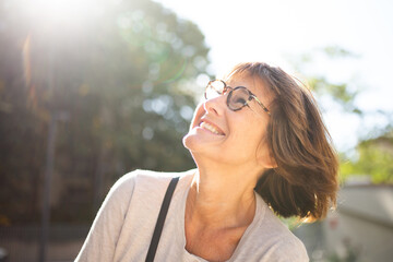 Close up happy older woman with glasses outside