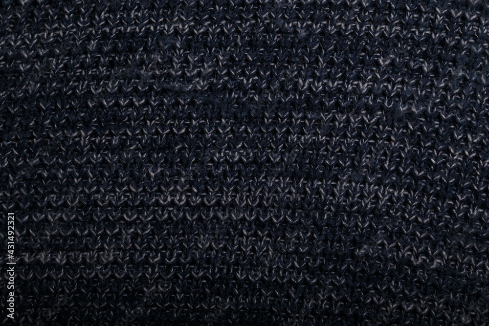 Fototapeta premium Knit dark blue fabric texture, background or backdrop. Textile, scarf or sweater textured surface. Warm accessories, clothing, fashion concept.