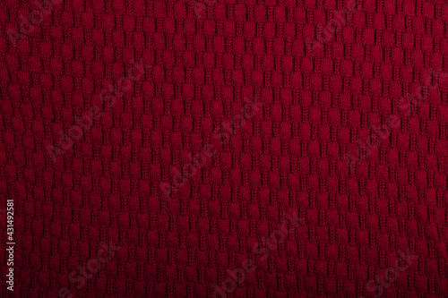 Knit burgundy fabric texture, background or backdrop. Textile, scarf or sweater textured surface. Warm accessories, clothing, fashion concept.