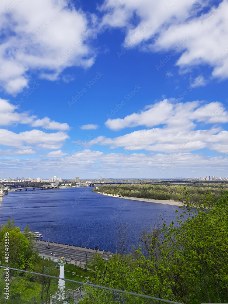 View of the city and the river from above. City landscape. Green park and nature. Panorama.