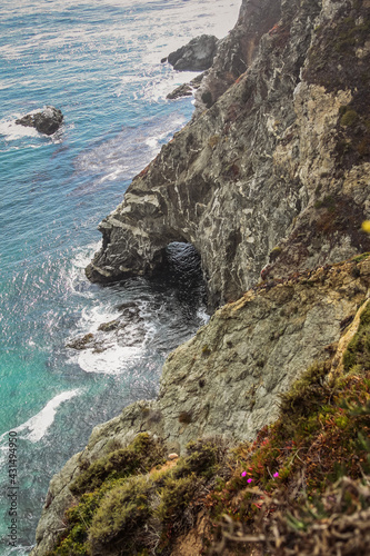 Scenic shot of the beautiful Big Sur Coast of California on a misty day, United States of America aka USA. Foamy waves in the ocean and rocky mountains