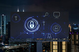 Padlock icon hologram on road billboard over panorama city view of Kuala Lumpur at night to protect business, Malaysia, Asia. The concept of information security shields.