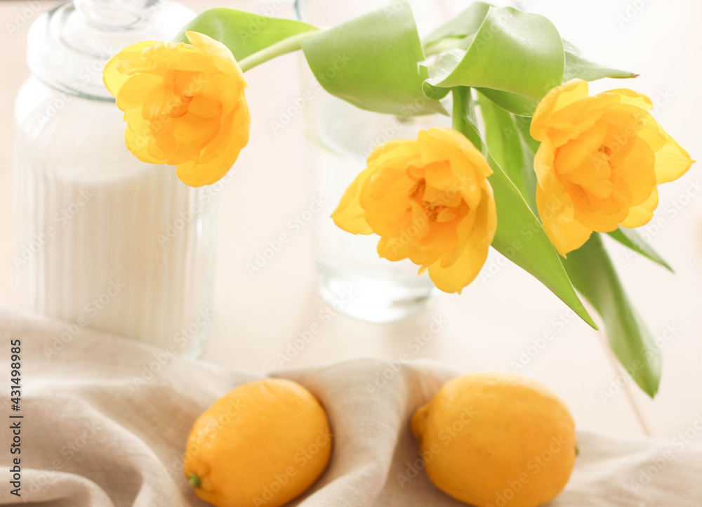 Yellow lemons, sugar and yellow tulips on the table. Conceptual Spring photo. Kitchen Photos. Interior.Vitamins 