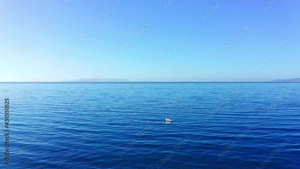 A small boat on the vast sea near Diakopto in Greece A small boat on the vast sea near Diakopto in Greece
