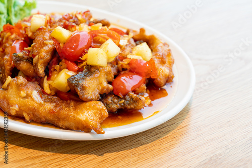 fried grouper fish topped with sweet ,sour and hot sauce