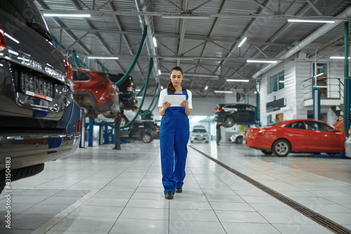 Female mechanic with laptop, car service