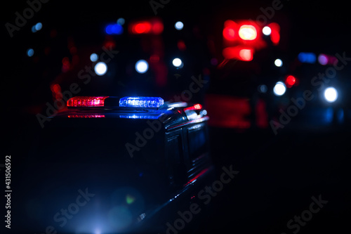 Police cars at night. Police car chasing a car at night with fog background. 911 Emergency response police car speeding to scene of crime. © zef art