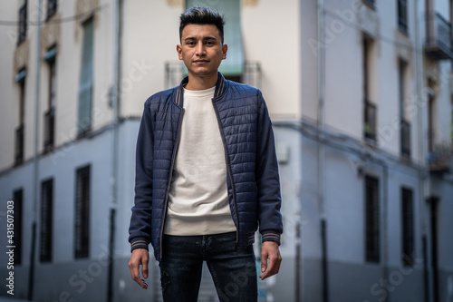Hispanic man wearing jeans and casual jacket