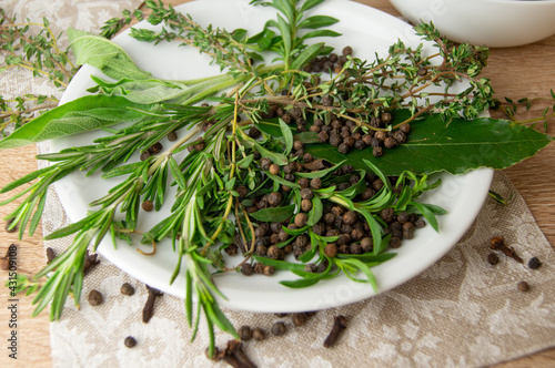 Konstfotografi Herbes de Provence and spices on a white porcelain plate.