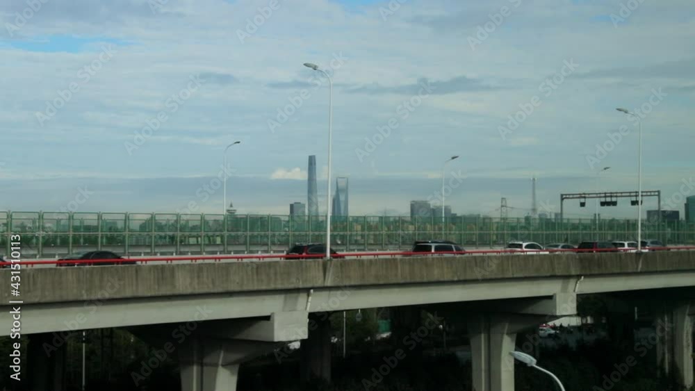 Slow Motion Panning Shot Of Vehicles On Bridge In City Against Cloudy Sky During Sunny Day - Shanghai, China