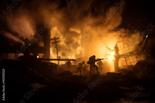 War Concept. Military silhouettes fighting scene on war fog sky background, World War Soldiers Silhouette Below Cloudy Skyline At night. Battle in ruined city.