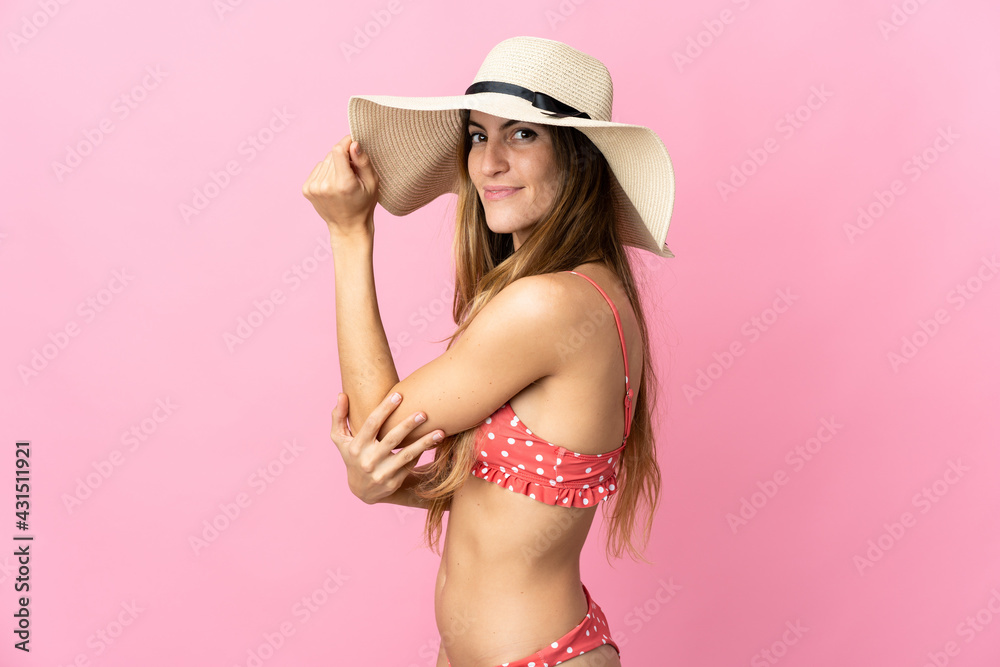 Young blonde woman over isolated pink background in swimsuit in summer holidays Young blonde woman over isolated pink background in swimsuit in summer holidays
