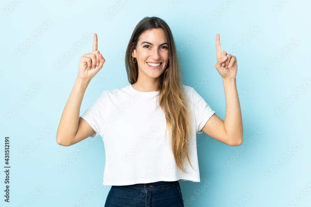 Young caucasian woman over isolated background pointing up a great idea