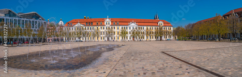 Panoramic view over major square with fountains in Magdeburg by Cathedral and Government Office, at sunny day and blue sky.