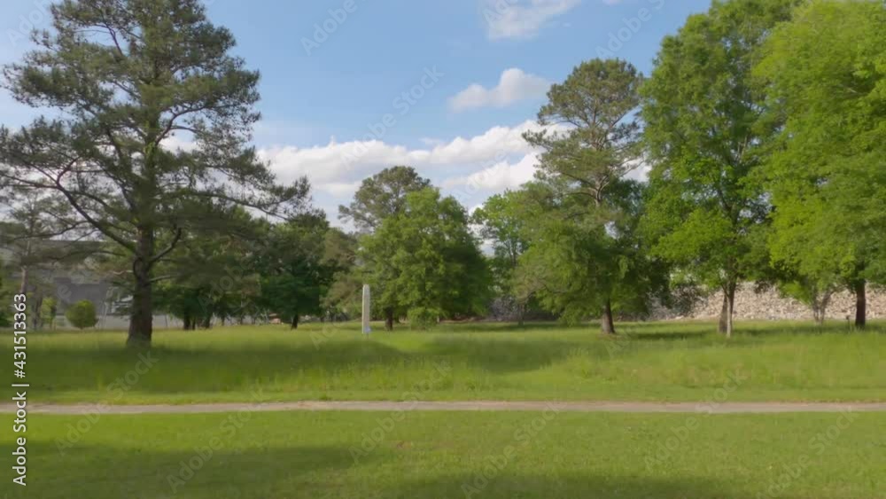 Pan of landscaping and nature with power poles and dam in distance Pan of landscaping and nature with power poles and dam in distance