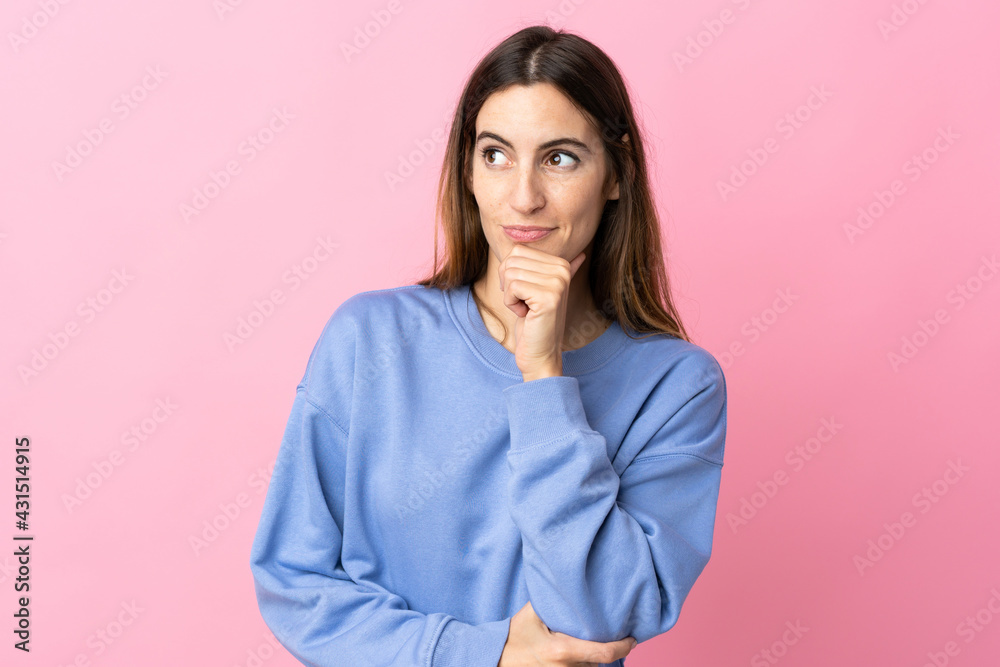 Young caucasian woman isolated on pink background thinking an idea while looking up Young caucasian woman isolated on pink background thinking an idea while looking up