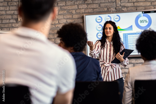 Group of diverse business people in conference meeting room during presentation. © Zoran Zeremski
