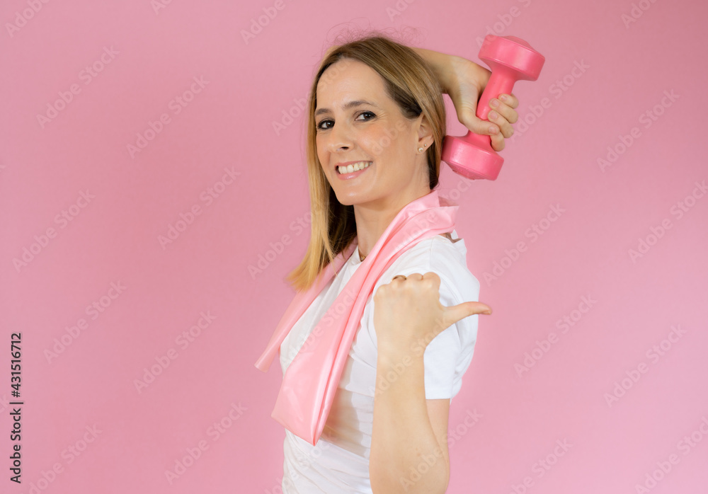 fitness woman working out with dumbbell over pink background fitness woman working out with dumbbell over pink background