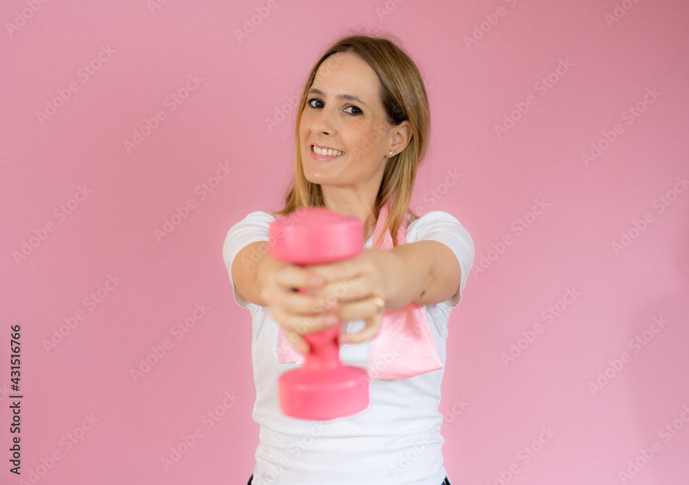 fitness woman working out with dumbbell over pink background fitness woman working out with dumbbell over pink background