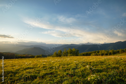 Mountain valley during bright sunrise, blooming meadow. Beautiful natural landscape. Adygea, do-do-gush
