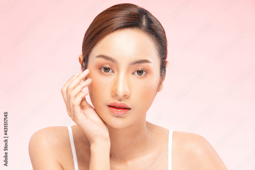 Wellness Asian young woman touch her cheek clean fresh and nutural pure skin,Pretty girl smile be moist skin on face shining like a model,Facial treatment of beauty woman,isolated on pink background Wellness Asian young woman touch her cheek clean fresh and nutural pure skin,Pretty girl smile be moist skin on face shining like a model,Facial treatment of beauty woman,isolated on pink background