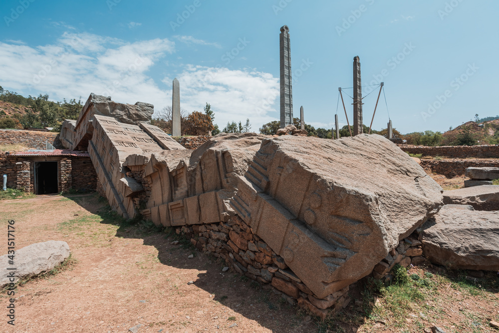 Aksumite civilization ruins, Ancient monolith stone obelisks behind Church of Our Lady of Zion, symbol of the Aksum, Ethiopia. UNESCO World Heritage site. Aksumite civilization ruins, Ancient monolith stone obelisks behind Church of Our Lady of Zion, symbol of the Aksum, Ethiopia. UNESCO World Heritage site.